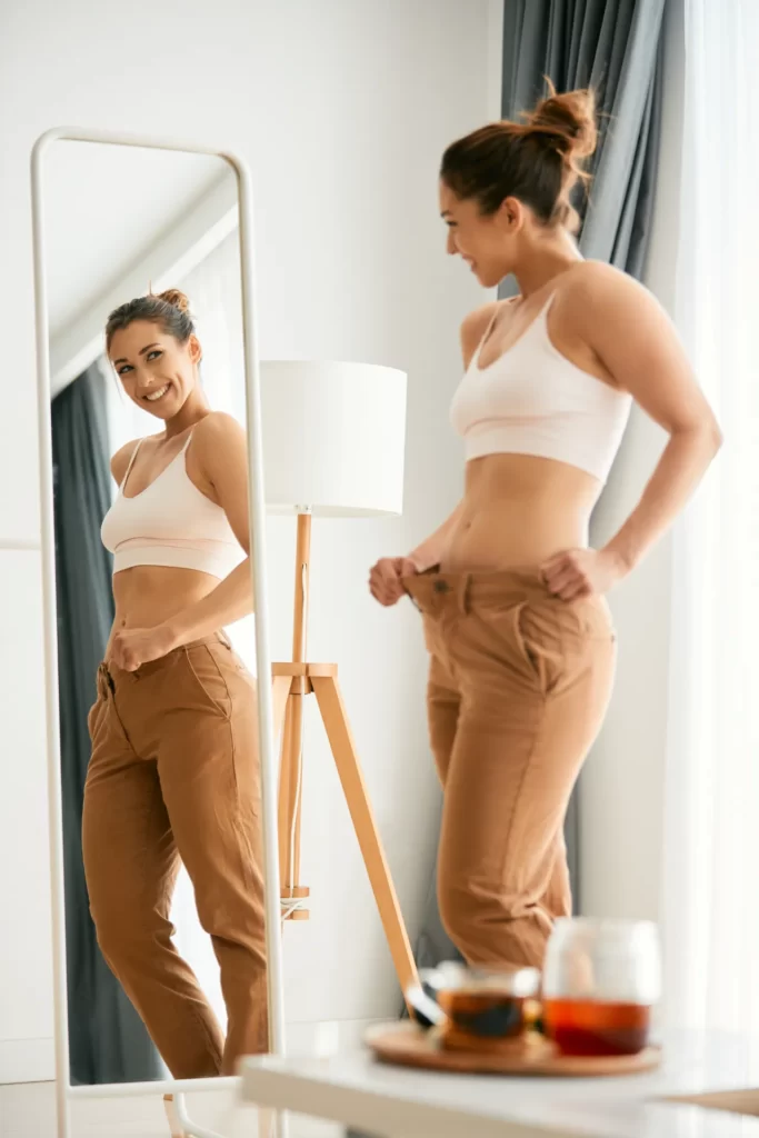 Woman smiling at home during a weight management journey