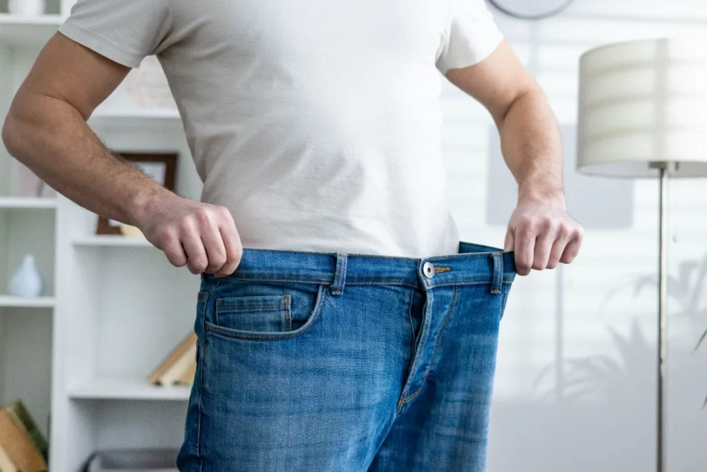 man wearing jeans too large after weight loss utc